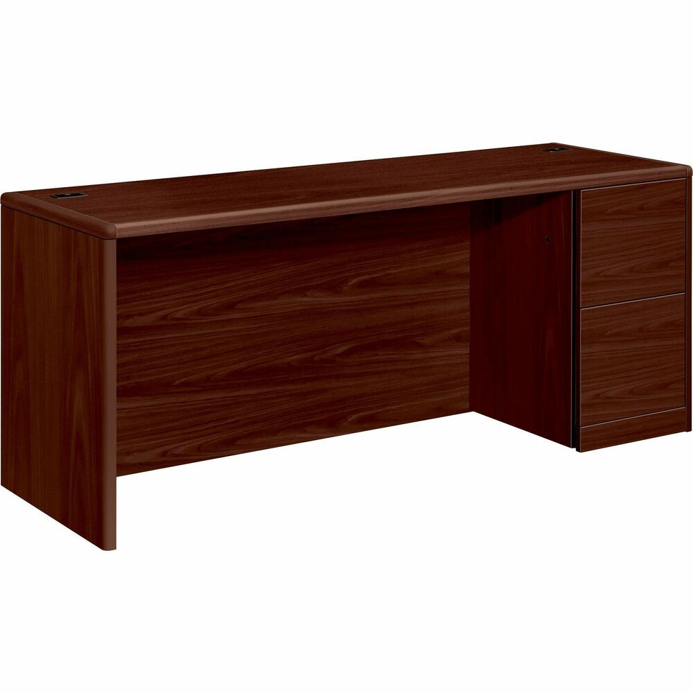 HON10707RNN - Right-pedestal credenza is part of HON 10700 Series Wood Laminate Furniture with an upscale design, stylish accent details, durable laminate surfaces and quality construction. Premium, multilayer, high-pressure, Mahogany laminate surface resists water, scratches and most solvents. Durable, 1-1/8" thick, solid-core, high-performance particleboard withstands frequent moving and handling. Design also features a full-height modesty panel, user-friendly waterfall edges and rounded corners. Credenza offers a core-removable lock and two file drawers that hold letter-size or legal-size filing. Mechanical interlock inhibits the extension of more than one drawer at a time. Five-sided construction allows easy drawer alignment. Cord management includes two grommets in the desktop and one-cord, pass-through grommet in top center of modesty panel for routing and hiding wires and cables.