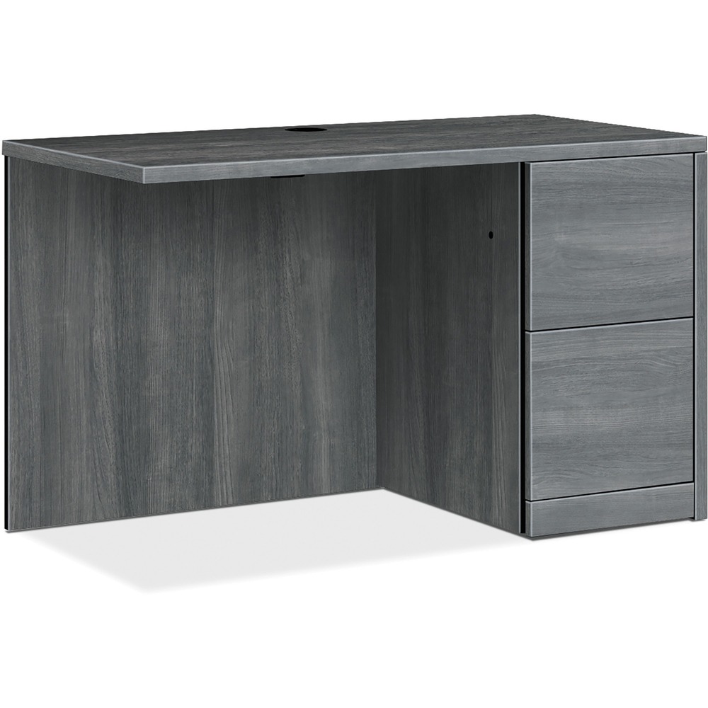 HON105905RLS1 - Return with single pedestal must be used with left-pedestal desks, desk shells, peninsulas or corner units in the HON 10500 Series Wood Laminate Furniture, a versatile collection for any office arrangement. Smooth, flat edges and a full modesty panel deliver a clean look. Scratch-resistant, spill-resistant and wear-resistant, Sterling Ash laminate on strong inner-frame construction assures trouble-free performance and long life. Return features one full pedestal on the right with two locking file drawers that include integrated hangrails for side-to-side letter-size and legal-size folders and front-to-back letter-size filing. Five-sided drawers operate on full-extension, ball-bearing suspension to ensure smooth, long-lasting operation. Non-freestanding return also has one worksurface grommet and one-cord, passthrough grommet in the top center of the modesty panel to reach wall electrical outlets and interchangeable, core-removable lock for quick, easy rekeying.
