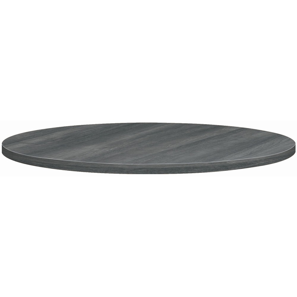 HONBTRND42NLS1 - Whether you're working here, there or anywhere Between, this table collection's got you covered. To get the most out of every inch of space and increase productivity, add this versatile, 42" diameter round tabletop to a variety of office areas: meeting spaces or casual open areas such as breakrooms, cafes or breakaway spaces. With pre-drilled holes for easy attachment to the 1-1/8" thick particleboard, the top can be easily added to a seated or standing height, HON Between X-base and Round Base with a counterweight (all three separately) to create a table that attracts everyone to lesser-populated spaces like nooks, hallways and everywhere in Between. Lightweight design allows easy reconfiguration within an environment. Top is covered in high-pressure laminate that is scratch-resistant, spill-resistant and stain-resistant so it will look great for years to come. Color of laminate and 2mm edgeband is Sterling Ash.