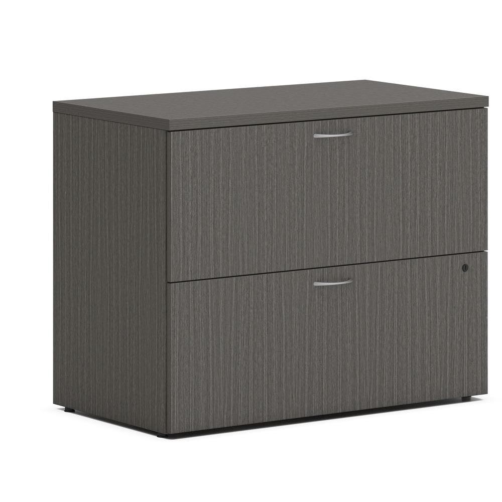 HONLLF3620L2LS1 - Two-drawer lateral file is part of the HON Mod Desk Collection that delivers simplicity and adaptability to enhance your productivity. The contemporary design feels perfectly at home in either a private office or an open floor plan. Lateral file can stand alone, or the top can be removed to convert it to a support pedestal for a Mod desk or credenza shell. It accommodates a large volume of filing in an efficient format that saves floor space, increasing the storage capacity of a workstation. Drawers are equipped with standard hangrails to hold either letter-size or legal-size hanging files. File folders are arranged side-to-side to take up less aisle space when drawers are opened. Steel ball-bearing, drawer suspensions operate easily and quietly. Leveling glides compensate for uneven floors. Durable, Slate Teak laminate is scratch-resistant, spill-resistant and stain-resistant. Slate Teak matches other Mod elements (sold separately) so you can create an office suite to fit your needs. More from the Manufacturer