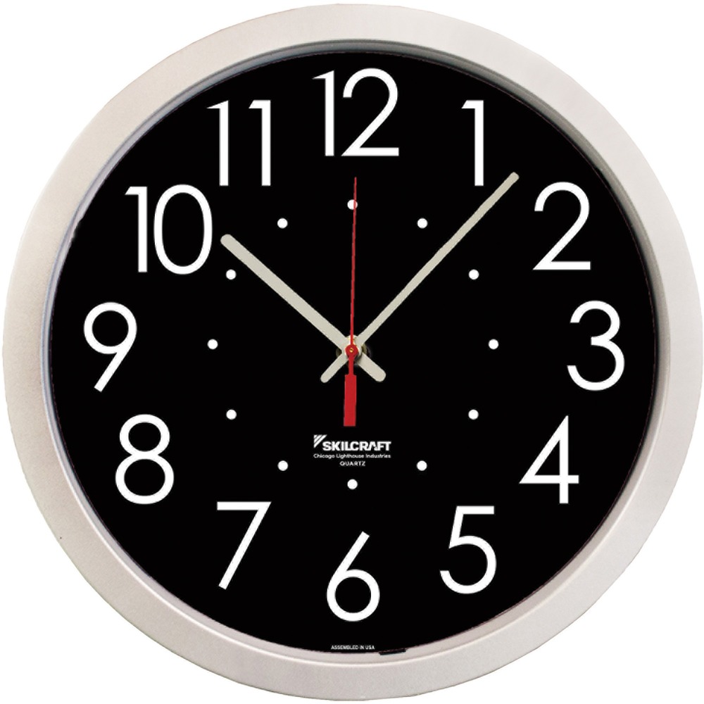 NSN6986560 - High Contrast Quartz Wall Clock with large, bold white numbers against a contrasting black background makes it easy to tell time from a distance. Quartz movement is accurate to within approximately 2 minutes per year. Shatter-resistant lens features a UV coating to protect against fading. High-impact plastic frame and body are made with 30 percent post-consumer recycled content. TAA-compliant, battery-operated wall clock with silver case uses one AA battery (not included).