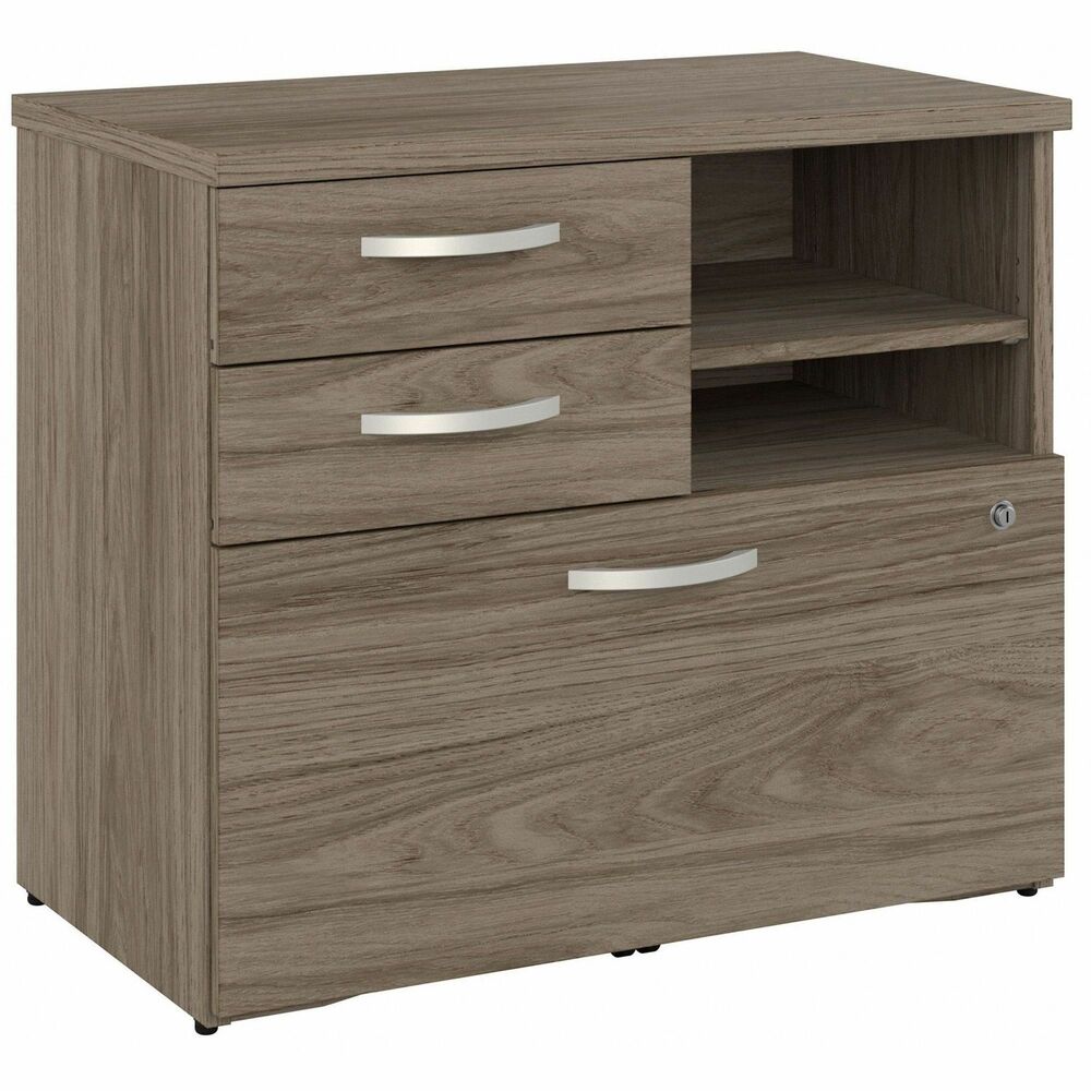 BSHHYF130MHSUZ - Hybrid Office Storage Cabinet with Drawers and Shelves offers a stylish, long-lasting workplace organization solution for the modern professional. Keep important documents, office supplies, work-in-progress and equipment in order so you can access the materials you need quickly and easily. A file drawer opens on smooth, full-extension, ball-bearing slides for an effortless reach to letter/legal/A4-size paperwork and can be locked to protect sensitive information. Two box drawers organize writing utensils, notepads and other supplies while the open shelves are ideal for frequently used items. Cabinet is thoughtfully designed for maximum stability and includes hardware to anchor the file cabinet with shelves to a wall, making it a safe choice for use in virtually any home or professional office environment.