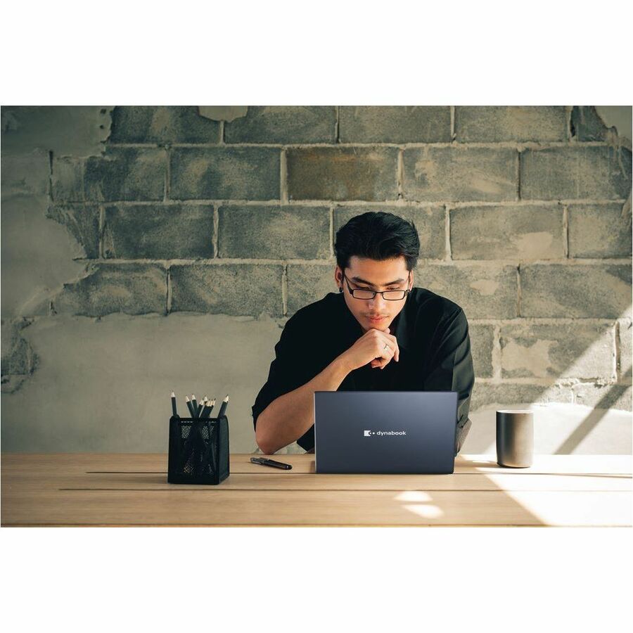 Dynabook Satellite Pro C50K business laptop with 15.6-inch Full HD display and dark blue chassis — life-style view