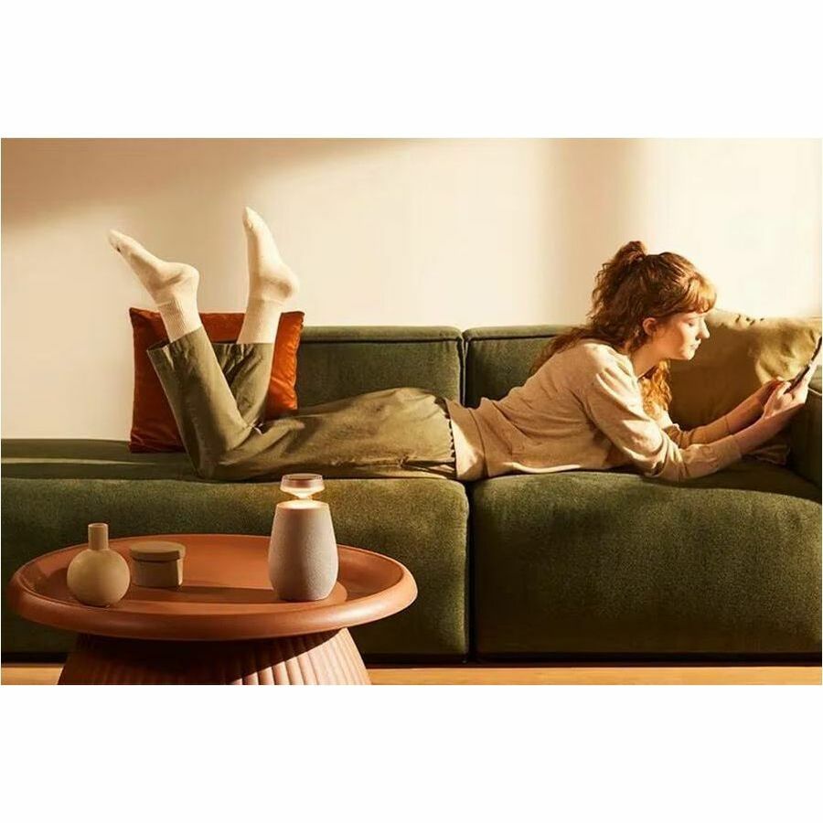 LG XBOOM 360 XO2 beige wireless speaker with 360-degree sound and ambient lighting — life-style view
