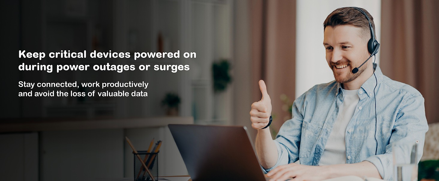 The background shows a workspace setting with a person at their system presumably powered by a back-UPS