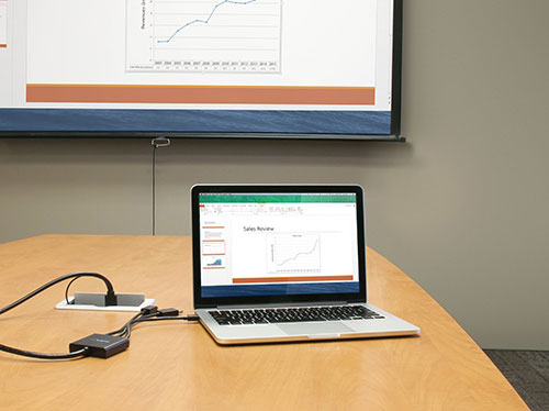 Faisant une prèsentation utilisant l'adaptateur pour connecter un ordinateur portable à un vidèoprojecteur HDMI